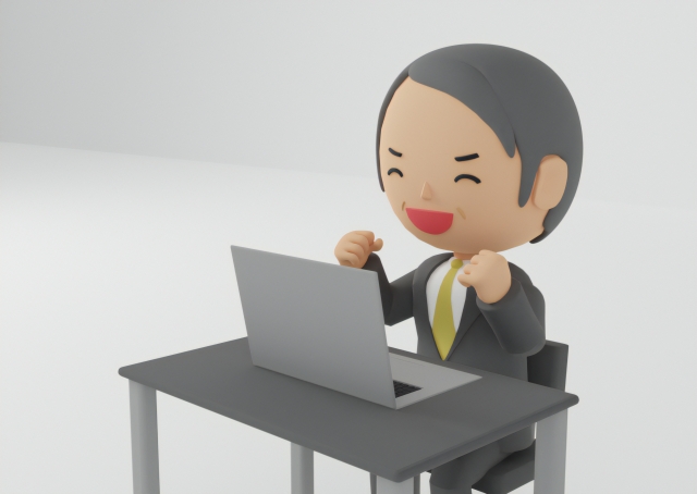 パソコンを見てガッツポーズするおじさんの人形の画像