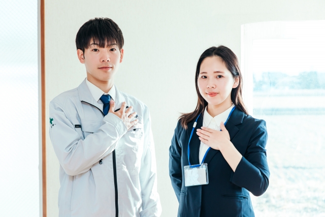 作業服とスーツの男女の画像